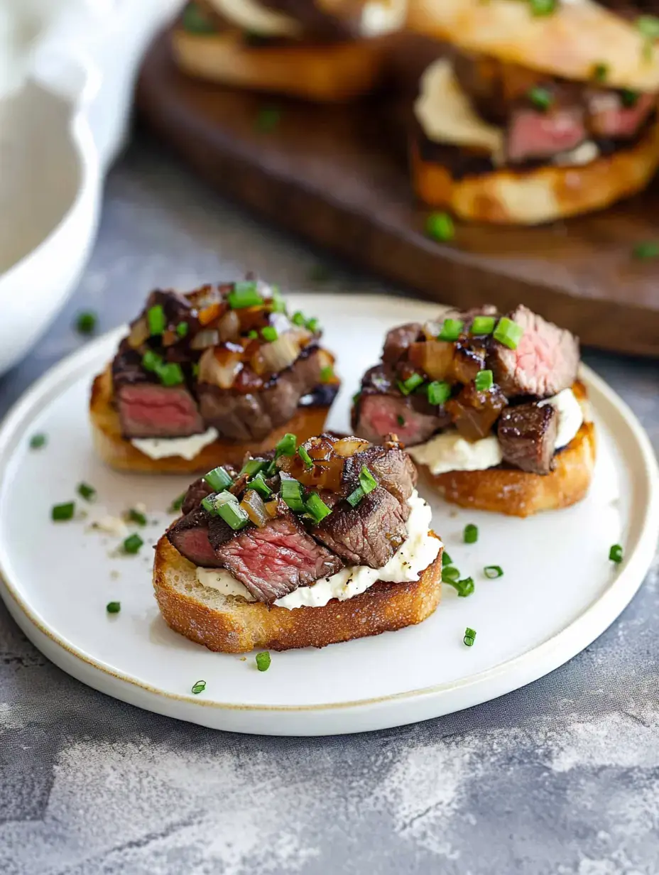 A plate of toasted bread topped with slices of beef, creamy sauce, caramelized onions, and chopped chives.