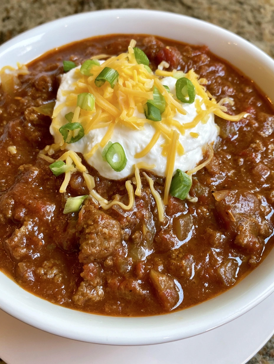 Thick homemade ground beef chili served hot with classic toppings