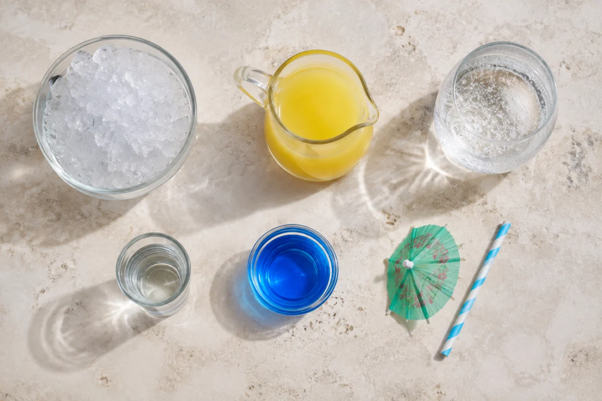 Ingredients for a Blue Ocean cocktail including crushed ice, coconut rum, pineapple juice, blue curacao, and lemon-lime soda